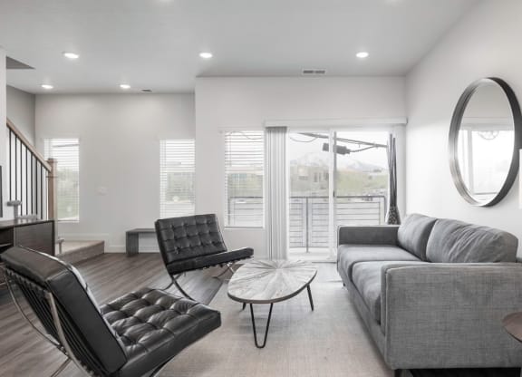 a living room with a couch and a chair and a table