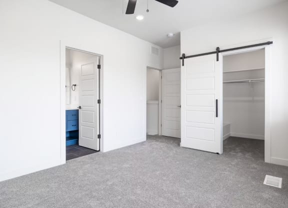 a room with white walls and a closet with white doors