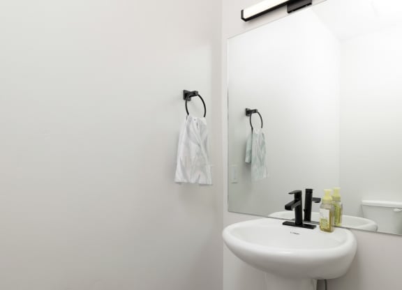 a white bathroom with a sink and a mirror