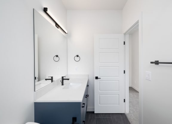 a white bathroom with a sink and a mirror