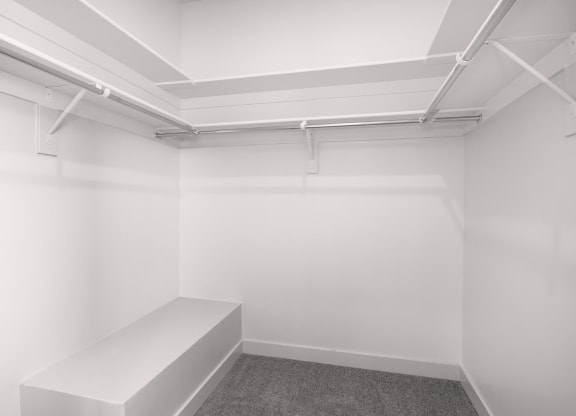 a small room with a white wall and a white bench