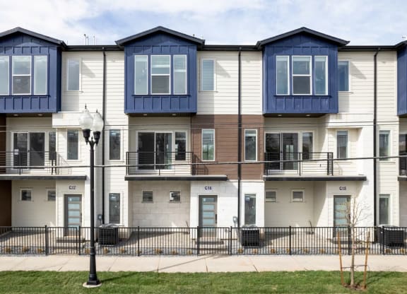a row of town houses with blue and white roofs