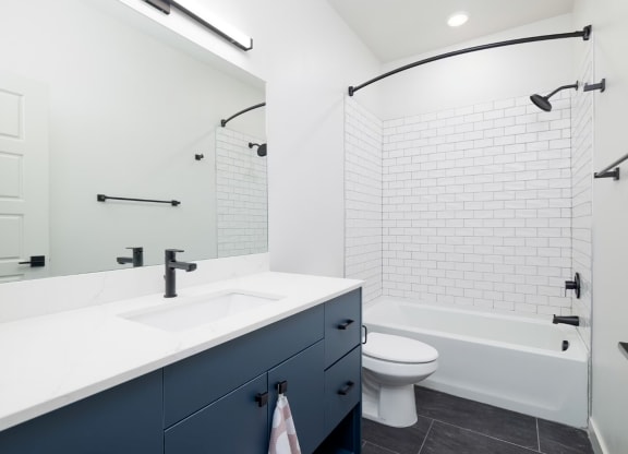 a white bathroom with a sink and a toilet