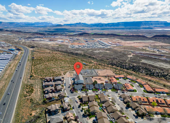 an aerial view of a neighborhood with a map pinpointing the location of a house