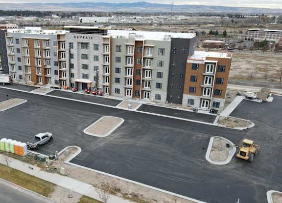 A large building with the word "RESERVOIR" on the side is surrounded by a parking lot.