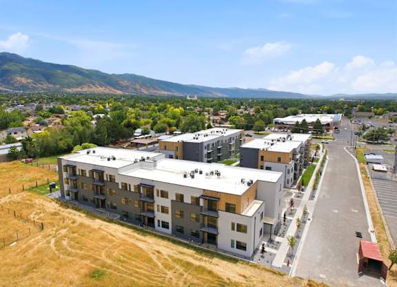 A large building complex with a parking lot in front of it.