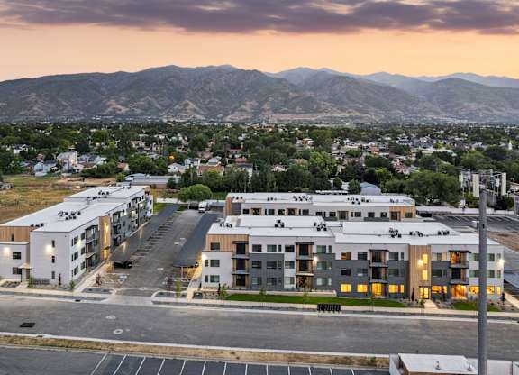 A large apartment complex is shown with a mountain range in the background.