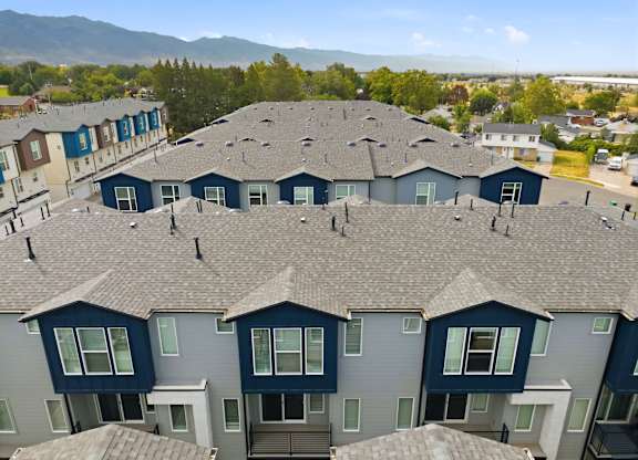 Apartment complex with grey roofs and blue trim.