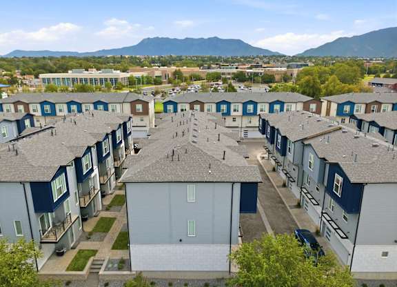 A large apartment complex with a mountain in the background.