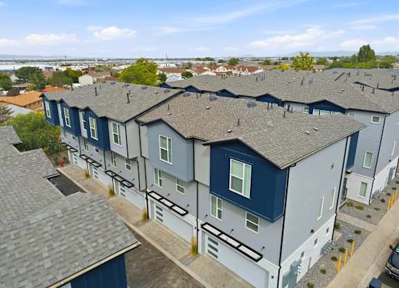 A row of houses with blue and grey exteriors.