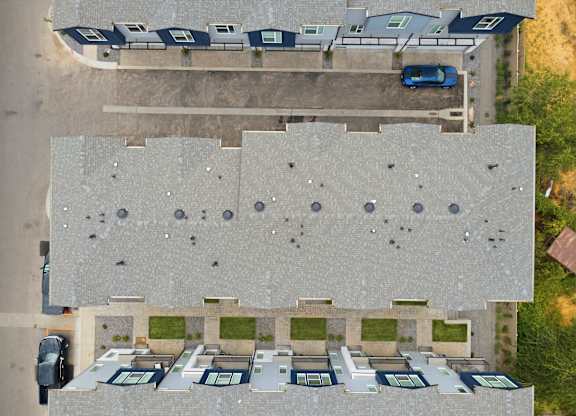 A parking lot with cars and a building in the background.