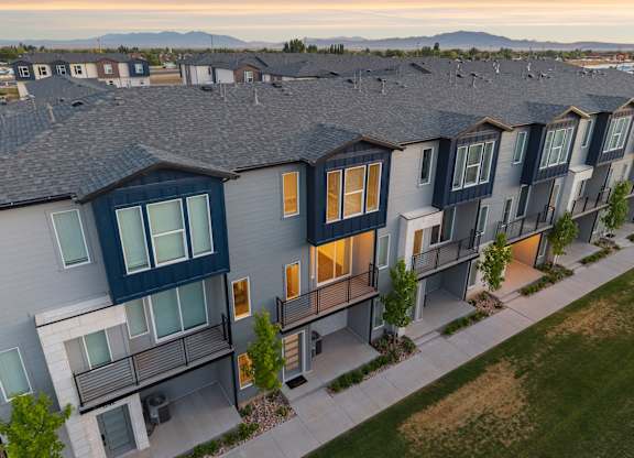 Apartment complex with grey roofs and balconies.
