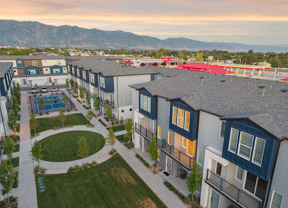 Apartment complex with a pool and a mountain in the background.