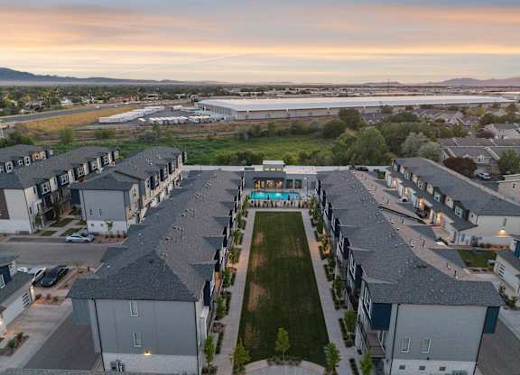 A residential area with houses and a park in the foreground.
