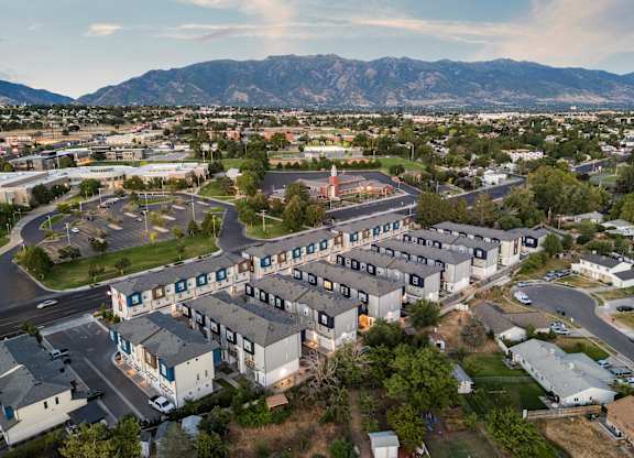 A large building complex with a parking lot in front of it.