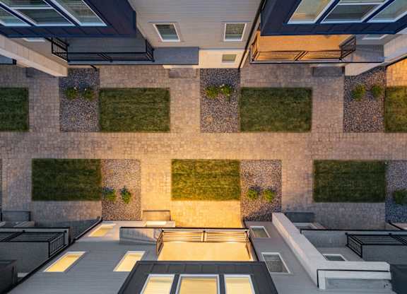 A modern building with a green wall and a glass ceiling.