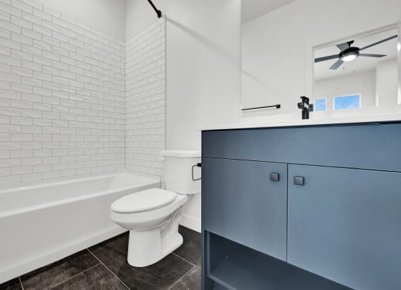 a bathroom with a white toilet and a tub and a sink