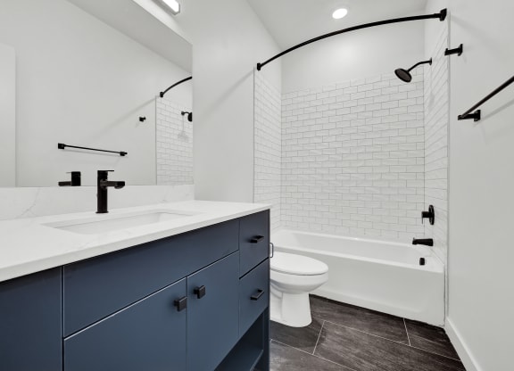 a bathroom with a sink and a toilet and a shower