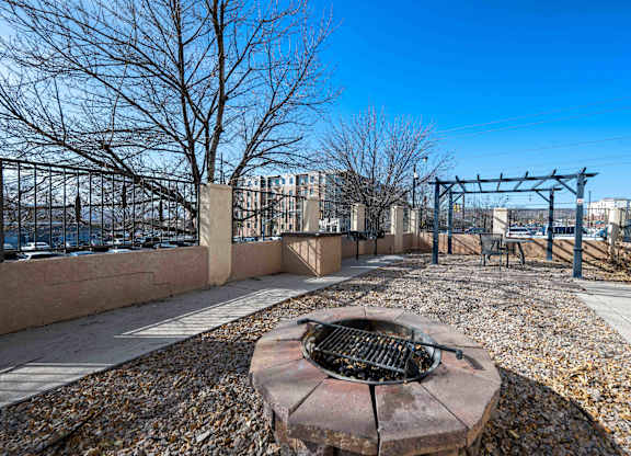 A fire pit sits in the middle of a gravel area.