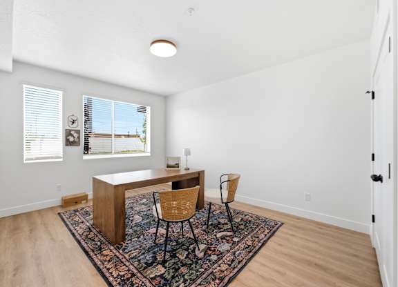 A room with a desk and chair in it.