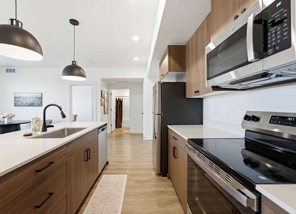 A modern kitchen with a black stove top oven.