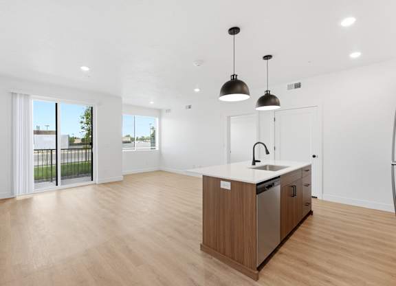 A kitchen with a sink and a refrigerator.