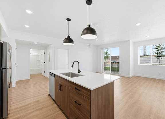 A modern kitchen with wooden cabinets and a white countertop.