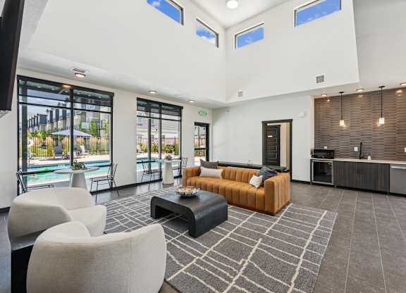 A modern living room with a pool view.