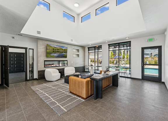 A modern living room with a pool outside.