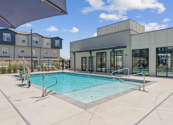 A swimming pool in front of a modern building.