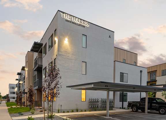 The Harris building is a modern structure with a parking area in front.
