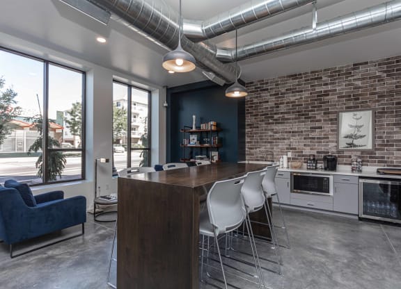 a kitchen and dining area with a brick wall