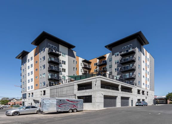 a large apartment building with cars parked in front of it