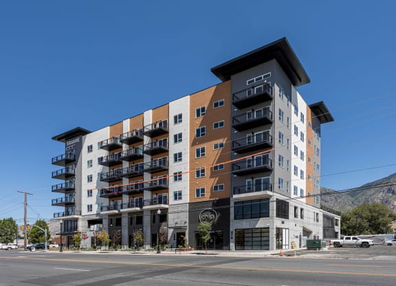 a large apartment building on the corner of a city street