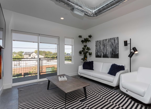 a living room with white couches and a coffee table