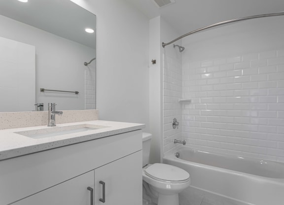 a bathroom with a sink and a toilet and a tub