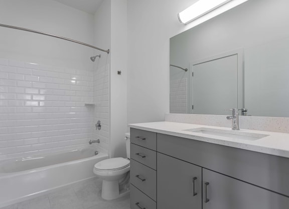 an empty bathroom with a sink toilet and shower