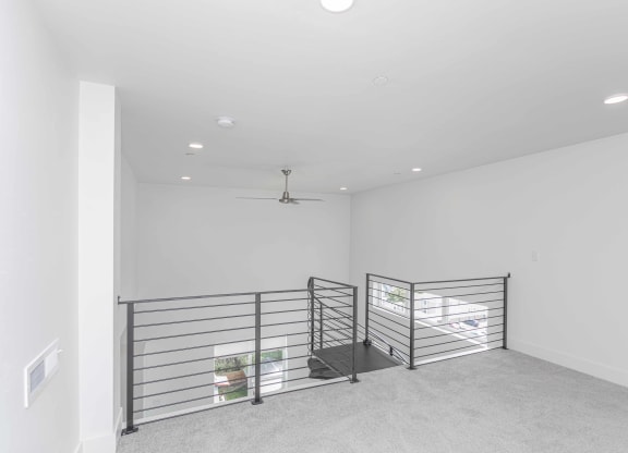 a large empty room with a metal railing
