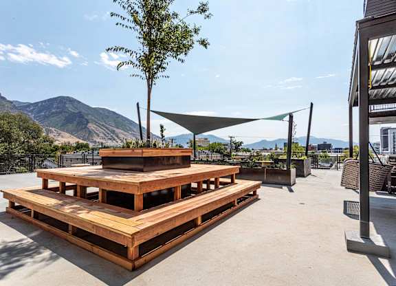 a patio with a picnic table and a view of the mountains