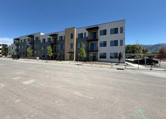 A large building with a parking lot in front of it.