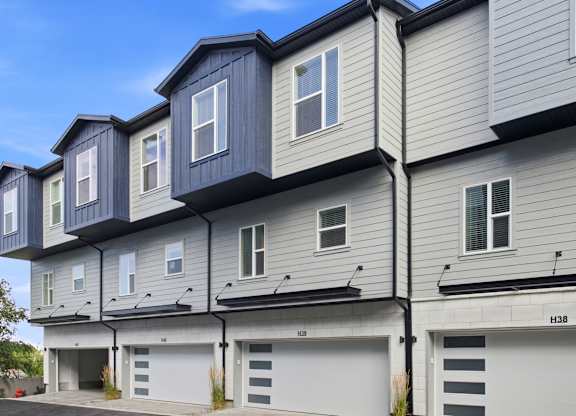 A modern two-story building with garages on the ground floor.