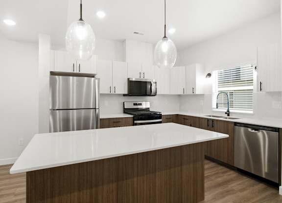 A modern kitchen with a large island in the center.