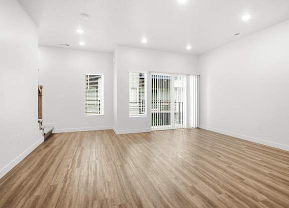 A room with wooden floors and white walls.