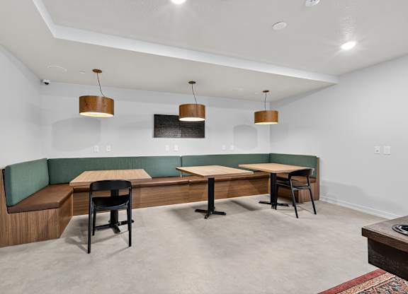 A room with a long table and chairs.