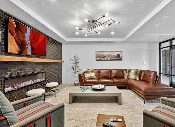 A modern living room with a fireplace and a painting on the wall.