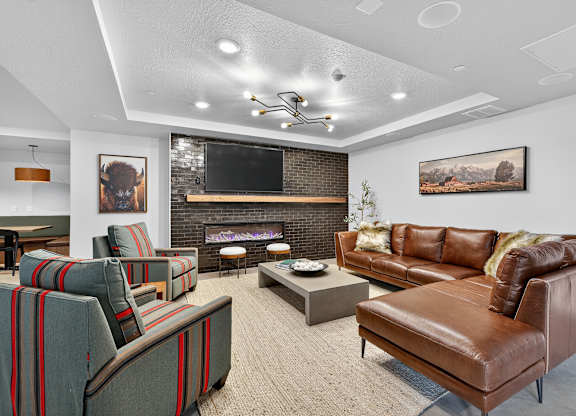 A living room with a fireplace and a flat screen TV.