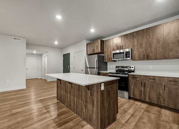 A kitchen with wooden cabinets and a white countertop.