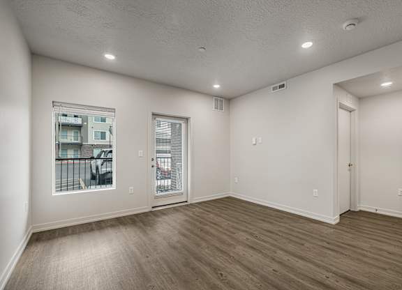 A room with a window and sliding glass doors.