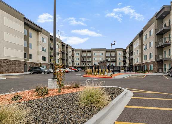 A parking lot in front of apartment buildings.