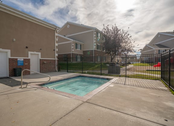a pool at the whispering winds apartments in pearland, tx